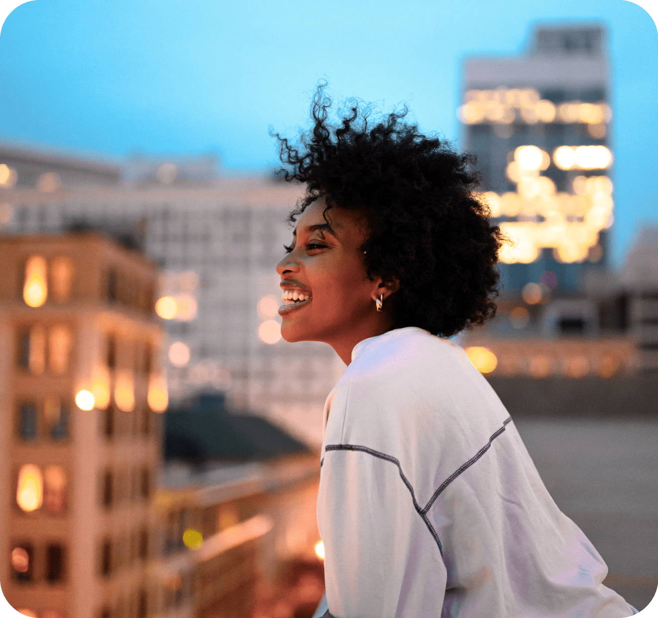 a girl with smiley face standing at a roof top